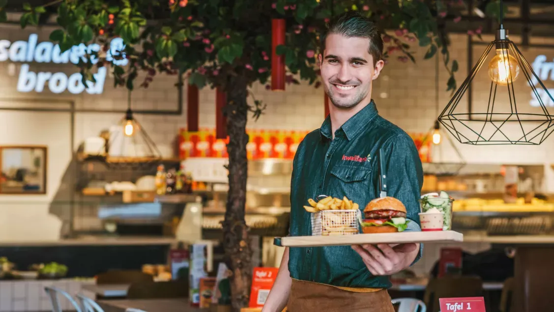 Kwalitaria entrepreneur serving food in a restaurant